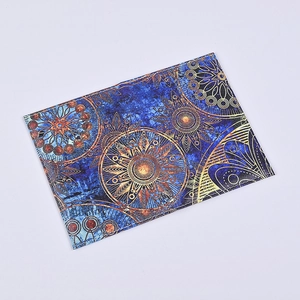 Macro shot of PU leather passport cover with gold mandala print and stitched edges