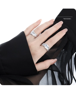 Detail of irregular brushed silver ring with blue stone inlay on hand model