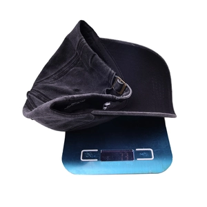 Detail view of a vintage washed denim baseball cap with mama embroidery weighing 77g
