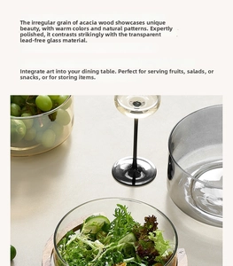 Detail of grey glass salad bowl with premium acacia wood stand for snacks
