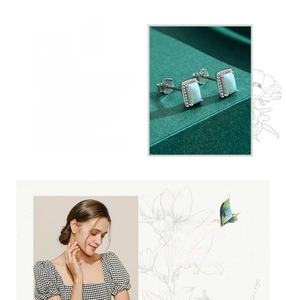 Detailed close-up and model view of rectangular opal stud earrings in 925 silver