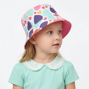 Close-up of kids bucket hat featuring colorful heart patterns and pink brim lining