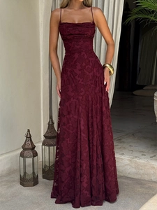 Gros plan sur le tissu jacquard en dentelle bordeaux avec détails plissés sur la robe longue
