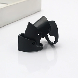 Close-up of matte black knuckle ring with three-segment articulated joint design
