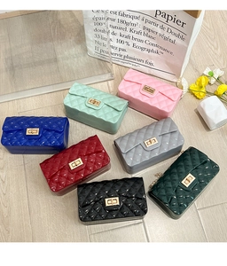 Flat lay of colorful jelly crossbody bags in seven vibrant colors with quilted patterns