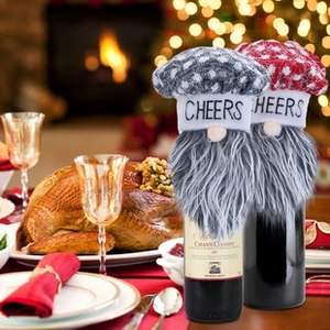 Christmas gnome wine bottle covers with knitted CHEERS hats in a cozy festive scene