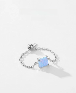 Detailed shot of an adjustable S925 sterling silver chain ring with square blue opal stone