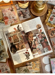 Close-up of vintage collage scrapbook papers with floral and character motifs on wood