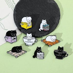 Detailed set of eight enamel pins featuring cute cats with books and coffee on stone decor