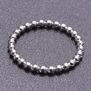 Macro view of a silver stainless steel ball chain ring with a polished metallic finish