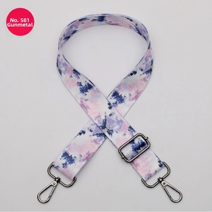 Detail showing adjustable tie-dye polyester strap with gunmetal swivel lobster clasps