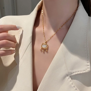 Elegant gold cloud auspicious lock necklace with opal stone and small bells on a model