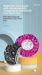 Close-up of thermal aluminum foil hair mask cap in rose red and black for hair treatment