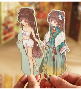 Detail of 3D folding DIY sticker paper dolls featuring traditional Chinese style outfits