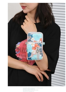 Detail of floral Oxford cloth phone bag with heart-shaped metal zippers and arm strap