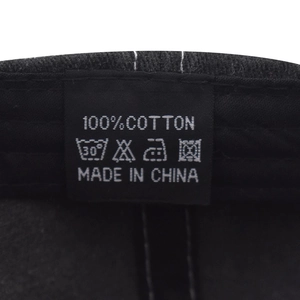 Close-up of internal wash care label showing 100% cotton material and made in China