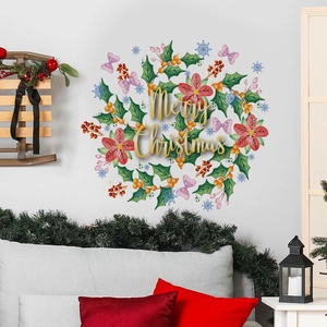 Christmas wall sticker with green holly leaves and Merry Christmas text in living room
