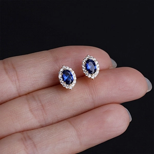 Detailed macro view of S925 silver vintage earrings with blue stone and gold plating