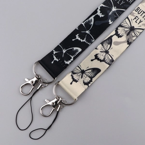 Detail of butterfly lanyards in black and beige with durable metal clasps and webbed texture