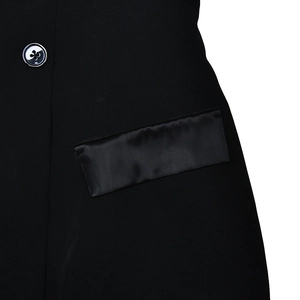 Detail of a black satin pocket and a cross-patterned button on a slim fit dress