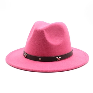 Macro view of bright fuchsia wool felt fedora featuring star studded leather band