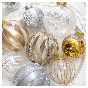 Detail of mixed champagne gold and silver Christmas ball ornaments on white embossed ceramic