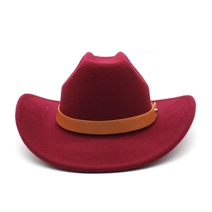Macro view of dark red wool cowboy hat with leather band and gold metal stud detail