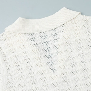 Detail showing white crochet knit polo collar with intricate hollow geometric pattern