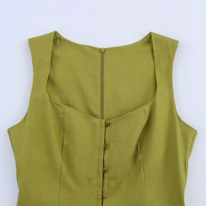 Detail of square neckline and button closure on olive green linen blend dress