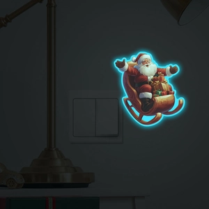 Glow-in-the-dark Santa Claus on a sleigh wall sticker glowing in a dark room environment