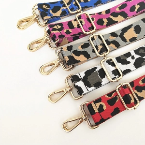 Detail of adjustable leopard print bag straps with shiny gold metal swivel hooks