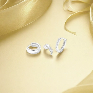 Close-up of 925 sterling silver turquoise jewelry set with cubic zirconia on silk