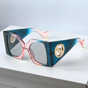 Detail of square sunglasses featuring gradient frames and golden swirl metal temple accents