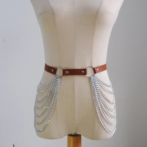 Detail of punk brown PU leather waist belt with multi-layered silver fringed metal chains