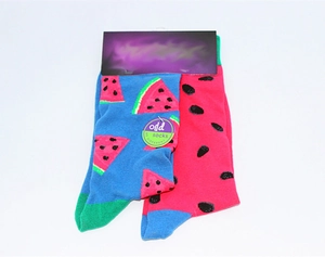 Detailed view of mismatching cotton socks with vibrant red watermelon patterns