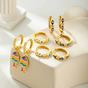 Bohemian gold hoop earrings set with colorful fish and enamel evil eye charms