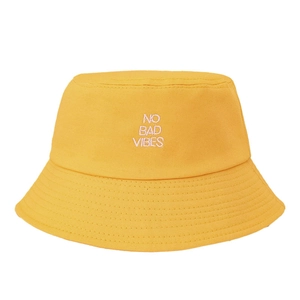 Ginger yellow cotton bucket hat with NO BAD VIBES white embroidery for sun protection