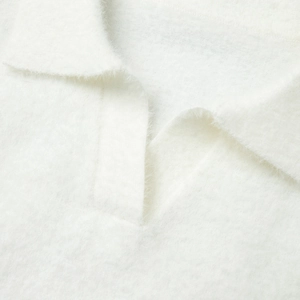 Detailed macro view of white polo collar with soft mohair texture on knitted sweater