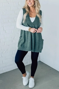 Detailed view of dark green V-neck knit vest texture with functional side pocket detail