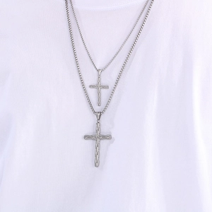 Layered silver stainless steel bead necklaces with cross pendants shown on a model