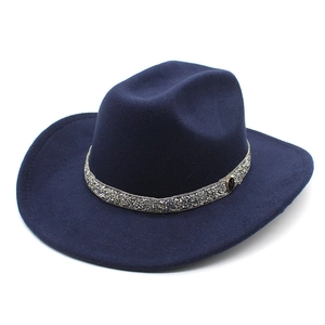 Close-up of navy wool felt fedora featuring a sparkling silver trim and M logo emblem