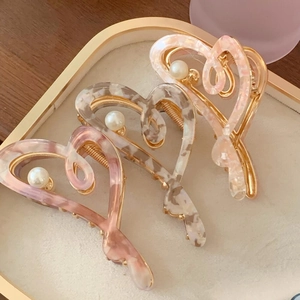 Elegant heart-shaped acetic acid hair claws with gold metal frame and pearl center
