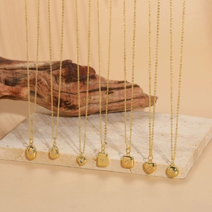 Collection of gold necklaces with geometric pendants and starburst cubic zirconia detail
