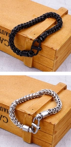 Detailed macro view of black matte and silver polished wheat chain link bracelets
