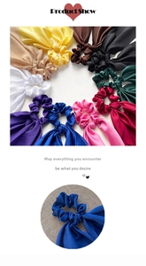 Close-up of colorful satin hair scrunchies with long ribbons and smooth silky texture