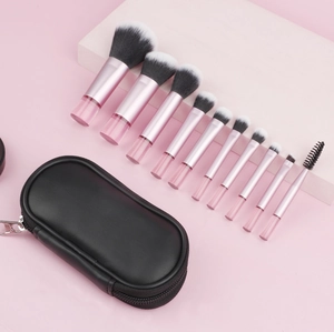Set of 10 pink makeup brushes with gradient bristles and a black zippered travel pouch