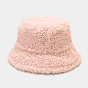 Detail of pink faux shearling bucket hat texture showing warm plush polyester fleece