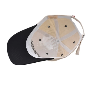 Detail view of cotton baseball cap interior showing wash label and inner stitching