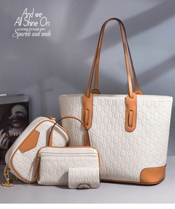 Macro shot of 4-piece cream tote bag set with brown handles and geometric texture