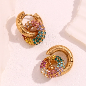 Macro shot of 18k gold plated earrings with rainbow cubic zirconia and water droplets